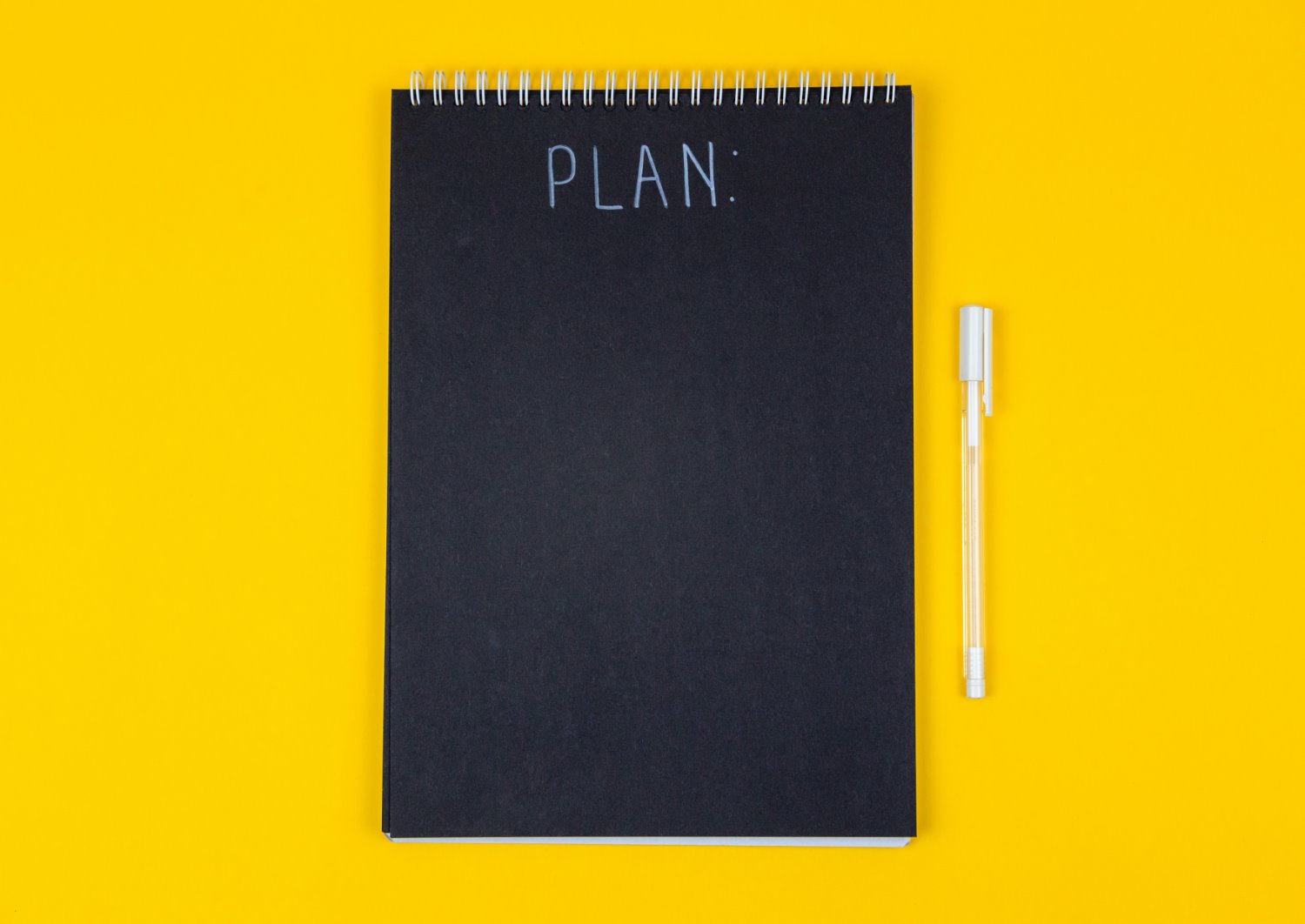 A black notebook with "plan" written across the cover.