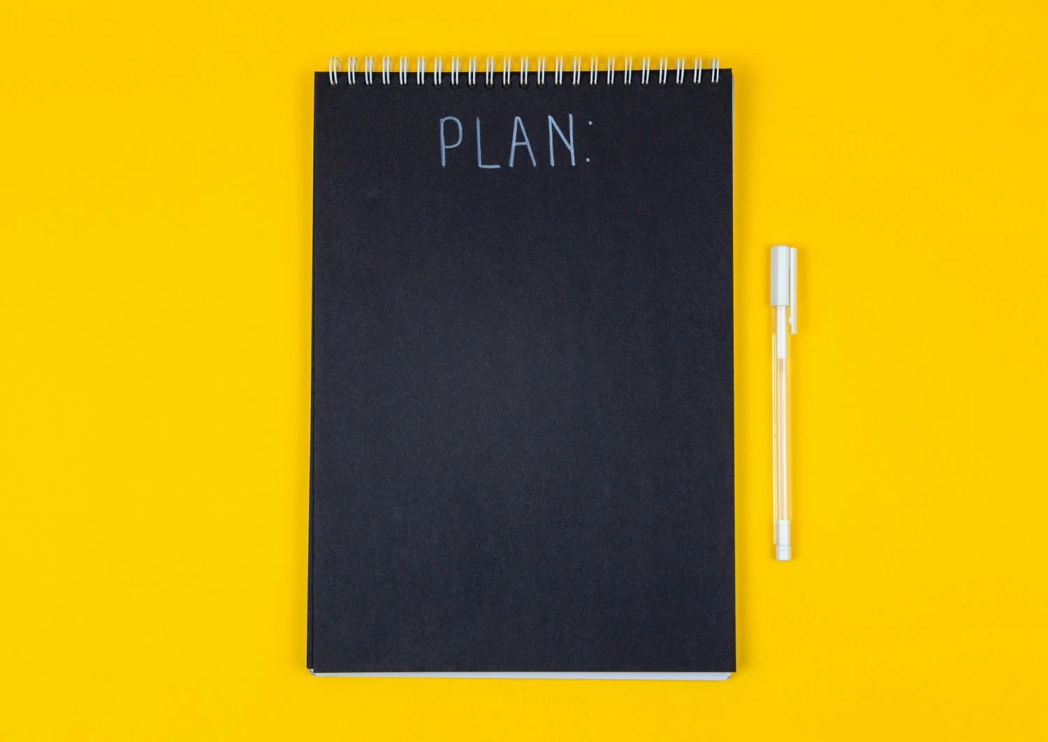 A black notebook with "plan" written across the cover.