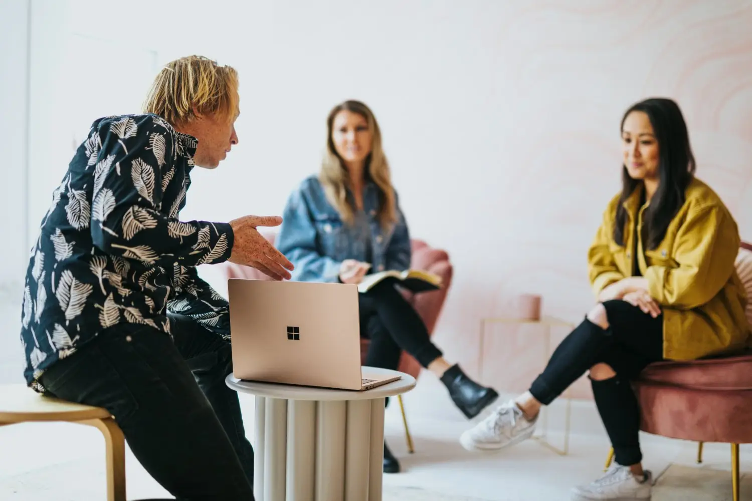 Several people collaborating around a computer in an office